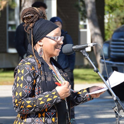 Laura Mae Lindo speaking at an outdoor event at Waterloo