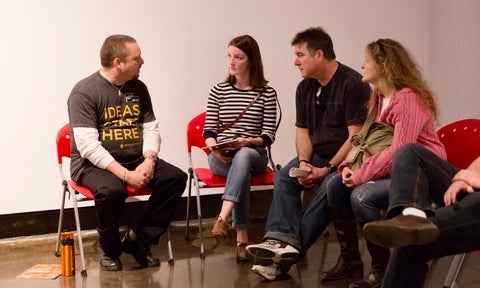 Eric Breugst speaking with a student and her parents