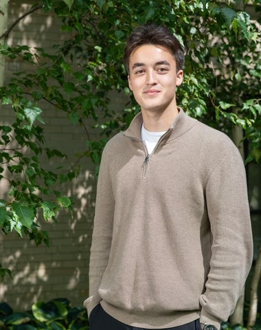 Jarett Dewbury standing in front of a tree.