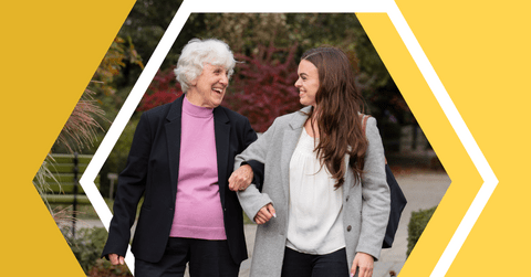 Waterloo e co-op student Katie aubrey walking with an elderly woman smiling. 