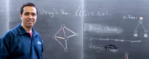 Sepehr Assadi at blackboard with Vizing's theorem banner