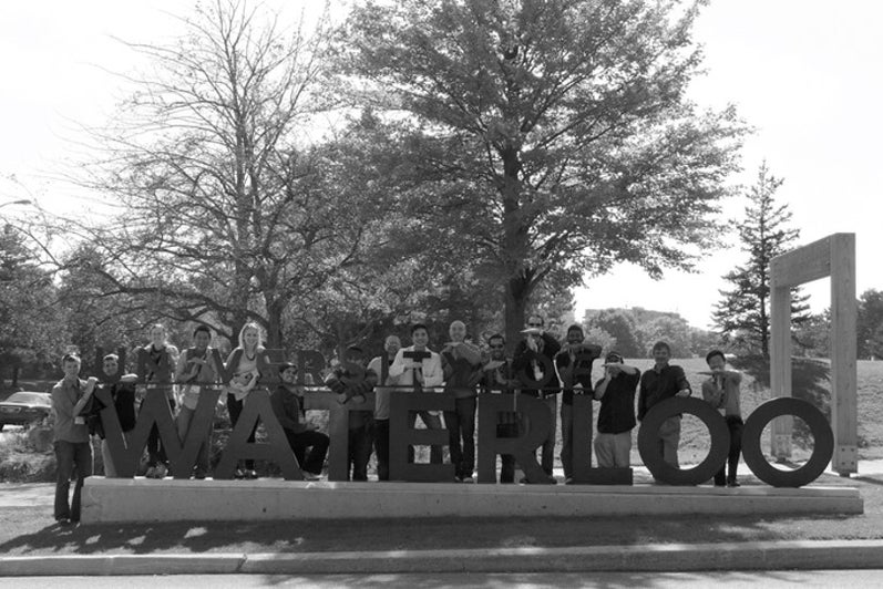 A group of engineering alumni with the Waterloo sign.