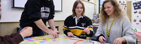 three students studying together