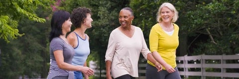 Four women walking on campus